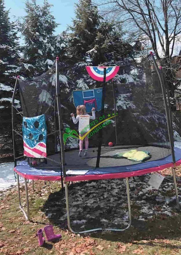 Side View Of Skywalker Trampoline And Kid Playing On It