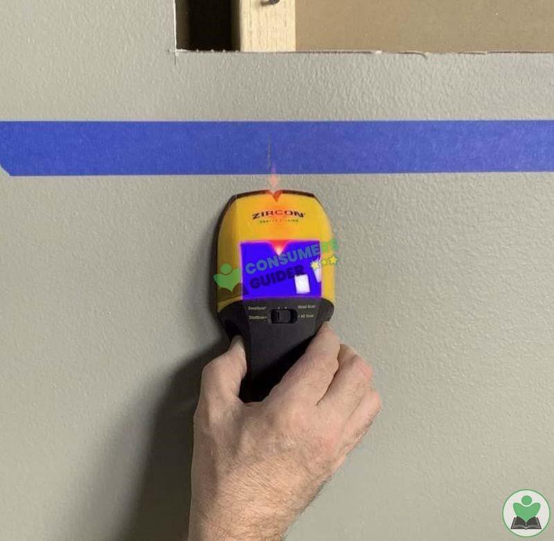 Running Stud Finder Against Wall To Install A Safe