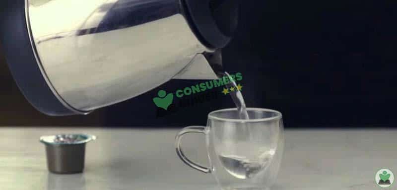 Filling Coffee Mug With Water To Make Espresso With Instant Coffee