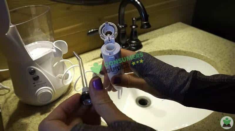 fixing the tip to the water flosser handle